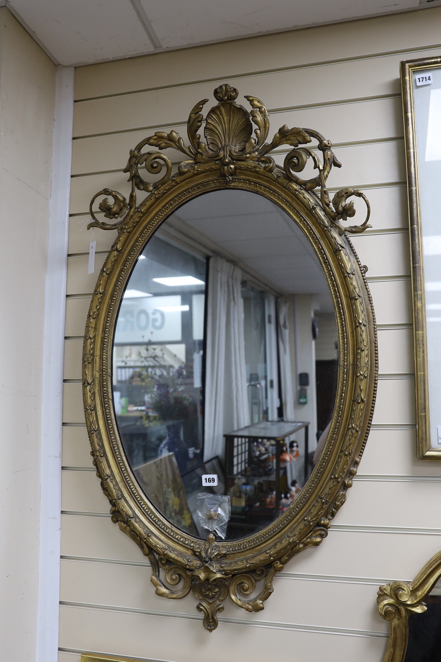A Victorian giltwood and gesso oval wall mirror, width 61cm, height 110cm